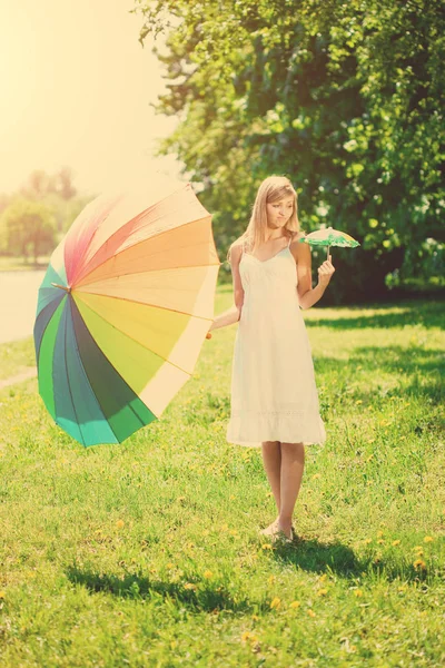 Smiling Woman Chooses Big Small Rainbow Umbrella Outdoors — Stock Photo, Image