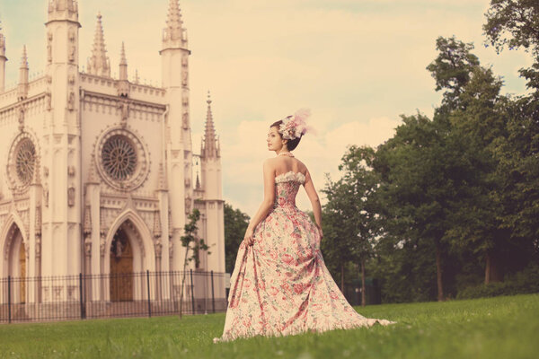 Portrait of vintage woman. The girl in the dress of the last century. Beautiful woman in long evening dress. Fairy Princess. Toned