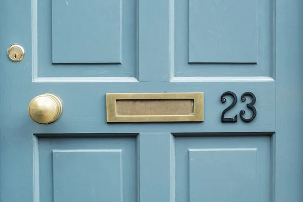 Nummer 23 op een blauwe deur Rechtenvrije Stockafbeeldingen