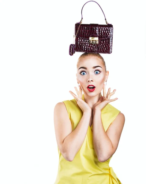 Fashion blonde girl holding red handbag on your head — Stock Photo, Image