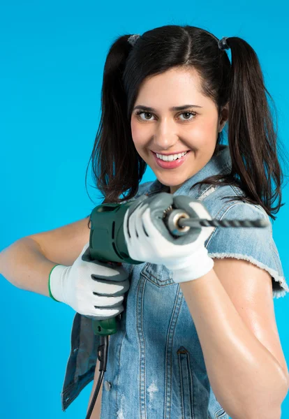 Young sexy woman holding a construction drill — Stock Photo, Image