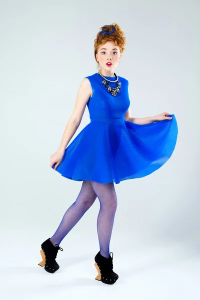 Full-length portrait of a woman in blue dress looking at camera — Stock Photo, Image