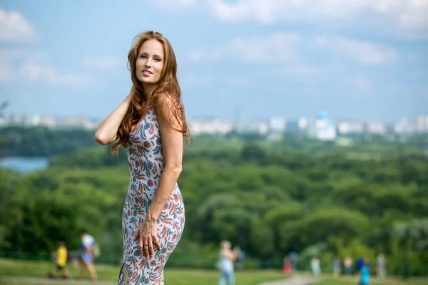 The red-haired girl on a background of blue sky — Stock Photo, Image