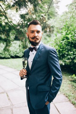 İz üzerinde duran şampanya flüt ile damat