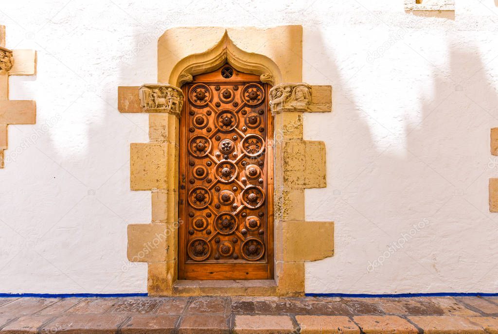 The wooden door of the museum Marisel de Mar, Sitges, Barcelona, Catalunya, Spain. Copy space for text.   