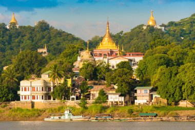 MANDALAY, MYANMAR - DECEMBER 1, 2016: Golden Pagodas in Sagaing hill, Burma. Copy space for text. clipart
