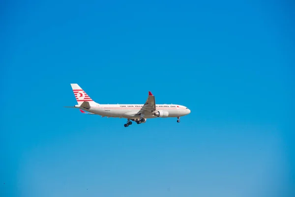 BARCELONA, SPAIN - AUGUST 20, 2016: Airplane of a Turkish airline in a blue sky. Copy space for text. Isolated on blue background. — Stock Photo, Image