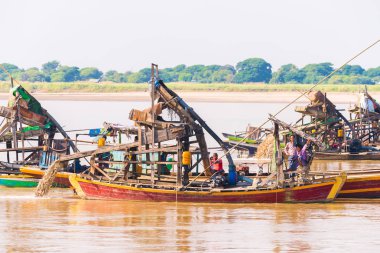 Mandalay, Myanmar - 1 Aralık 2016: Tırmık altın ve değerli taşlar, Irravarddy Nehri, Burma çıkarım için yüzer. Metin için yer kopyalayın.