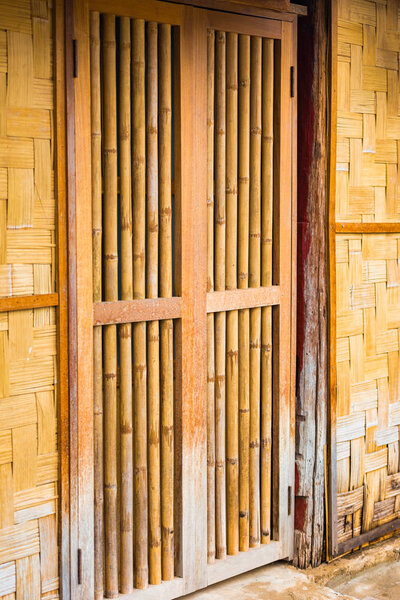 View of the bamboo door in Louangphabang, Laos. Close-up. Vertical