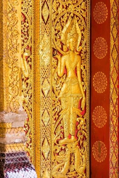 The bas-relief on the wall of the temple in Louangphabang, Laos. Close-up. Vertical. — Stock Photo, Image