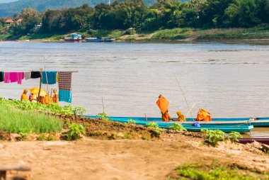 Luang Prabang, Laos - 11 Ocak 2017: Rahipler Nehri Nam Han Nehri üzerinde bir tekne. Metin için yer kopyalayın.