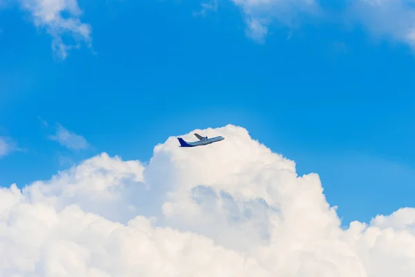 The plane in the sky against a background of white clouds, Luang Prabang, Laos. Copy space for text. — Stock Photo, Image