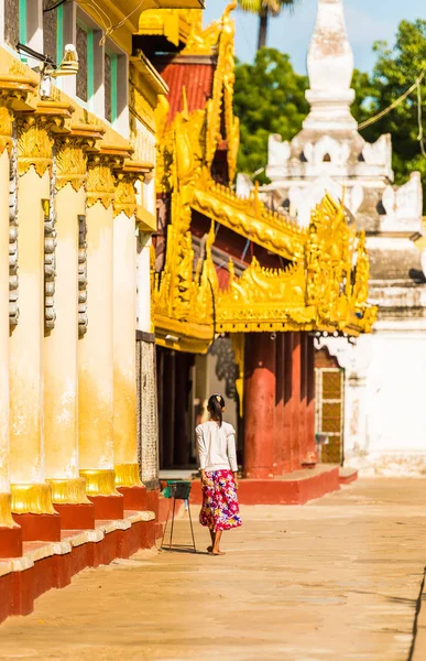 Woman near a buddhist temple in Bagan, Myanmar. Back view. Copy space for text. Vertical. — Stock Photo, Image