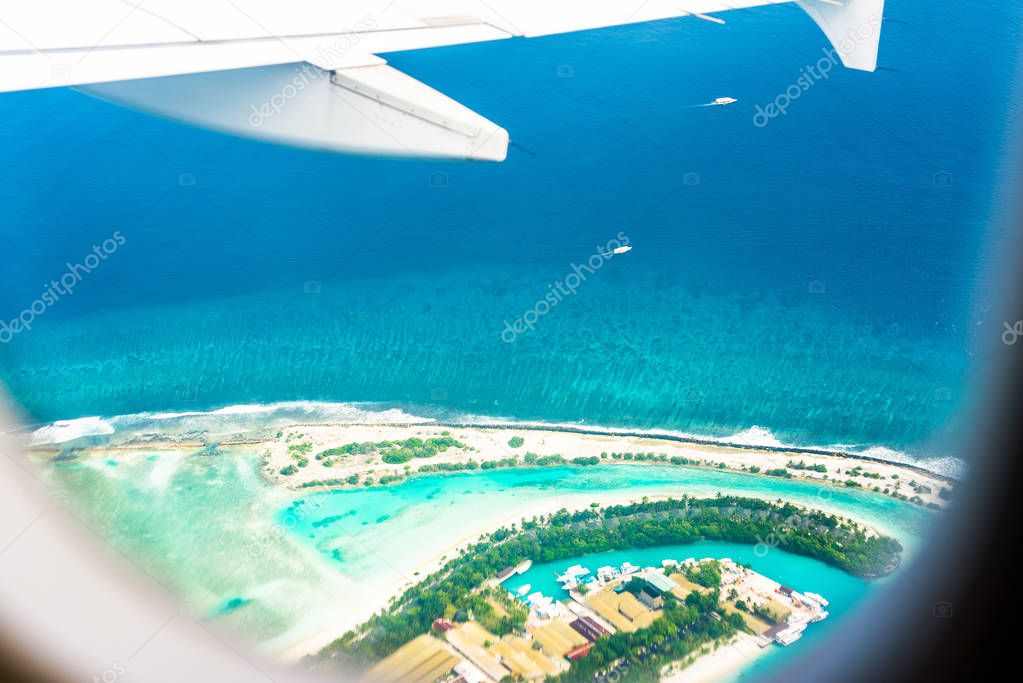 View of the island's sandy beach from the airplane, Male, Maldives. Copy space for text. 