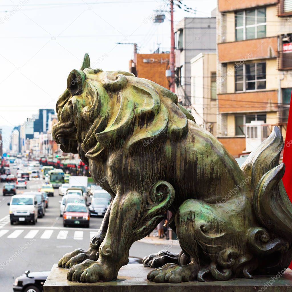 Sculpture of a lion on a background of the urban landscape in Kyoto, Japan. Close-up.  