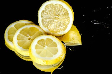 Sliced lemon with water drops  clipart