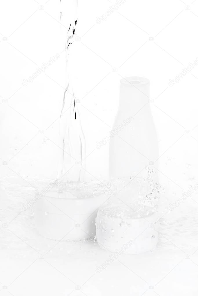 water drops falling on bottle and boxes