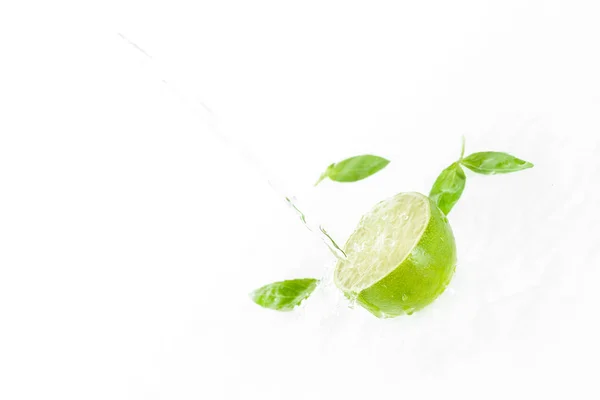 Half of lime with green leaves — Stock Photo, Image