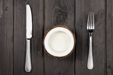 coconut half with metal fork and knife clipart