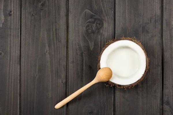 Ripe coconut with milk and spoon — Stock Photo, Image