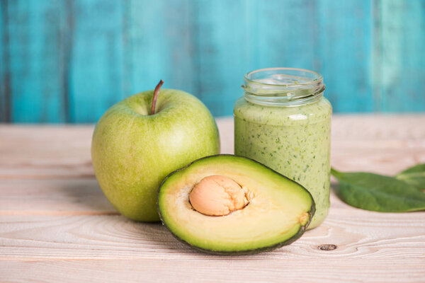 apple with avocado and smoothie in glass jar