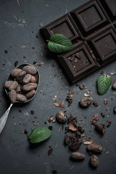 Barretta di cioccolato e cucchiaio con fagioli di cacao — Foto Stock
