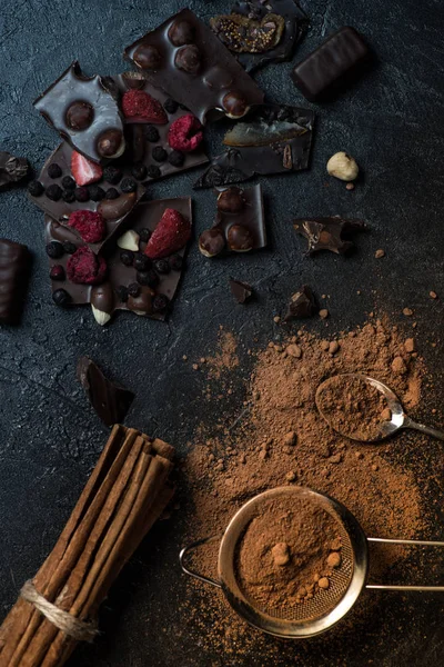 Pieces of chocolate with nuts and berries with cinnamon — Stock Photo, Image