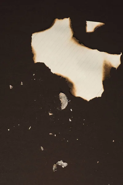 Burned pieces of empty writing paper — Stock Photo, Image