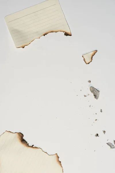 Pieces of paper sheet with burned edges — Stock Photo, Image