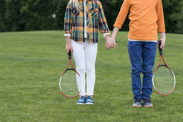 Kids with badminton racquets — Stock Photo, Image