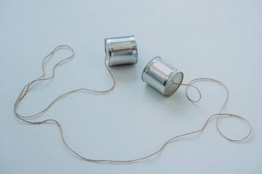 aluminium tin cans connected with rope clipart