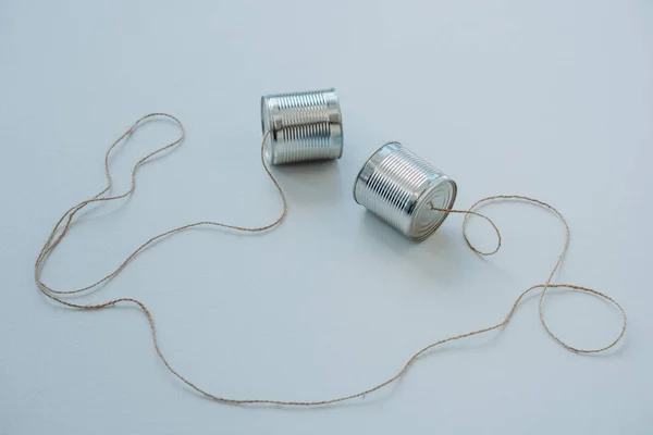 Aluminium tin cans connected with rope — Stock Photo, Image