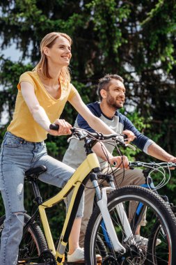 couple riding bicycles clipart