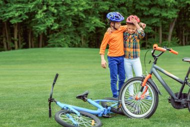 kids standing near bicycles clipart