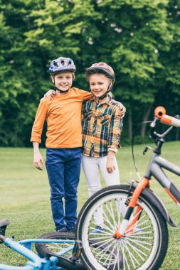 children with bicycles at park clipart