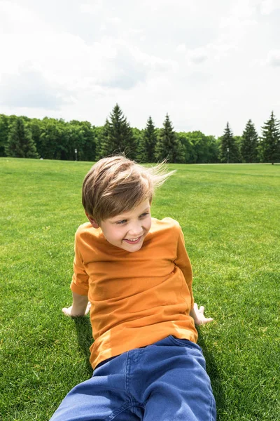 Boy resting on grass — Free Stock Photo