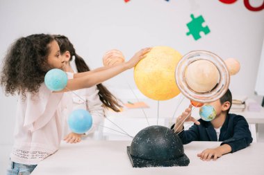 Schoolchildren with solar system   clipart
