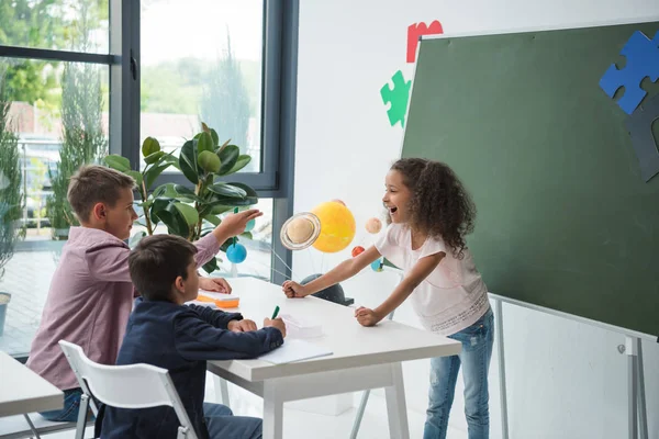 Multiethnic schoolkids in classroom — Stock Photo, Image