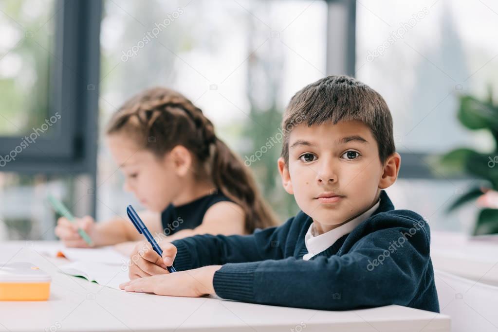 Schoolkids studying in classroom