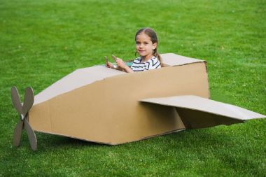 Girl playing with plane in park clipart