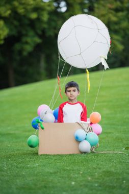Boy playing with air balloon clipart