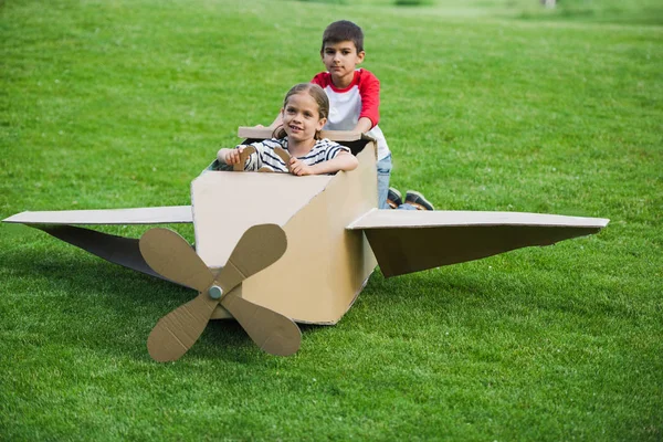 Children playing with toy plane — Stock Photo, Image