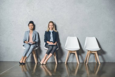 multicultural businesswomen waiting for interview clipart