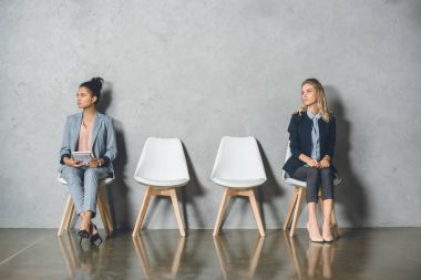 multicultural businesswomen waiting for interview clipart