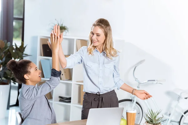 Multiethnic businesswomen giving high five Stock Picture