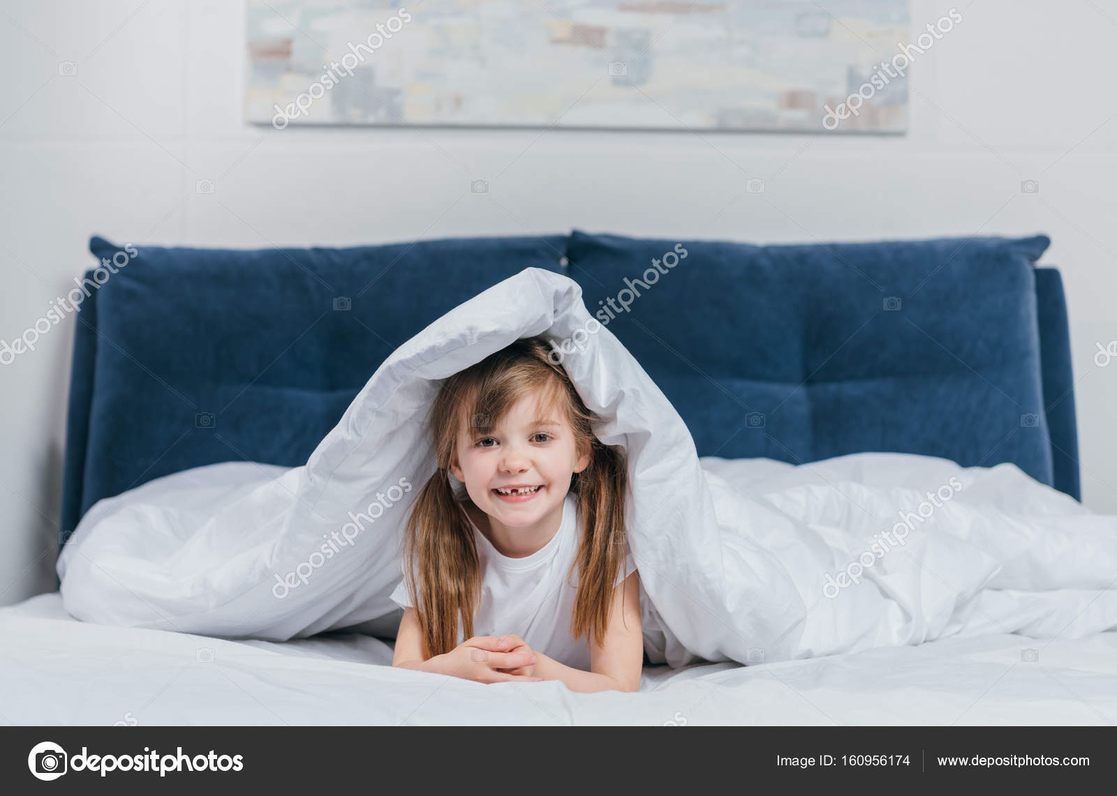 Girl hiding under blanket Stock Photo by ©alebloshka 160956174