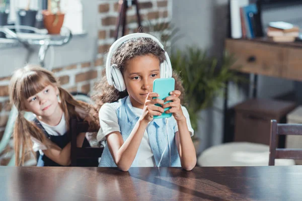 Multicultural girls with digital devices — Stock Photo, Image