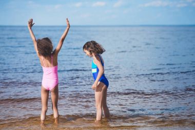 girls playing at seaside clipart