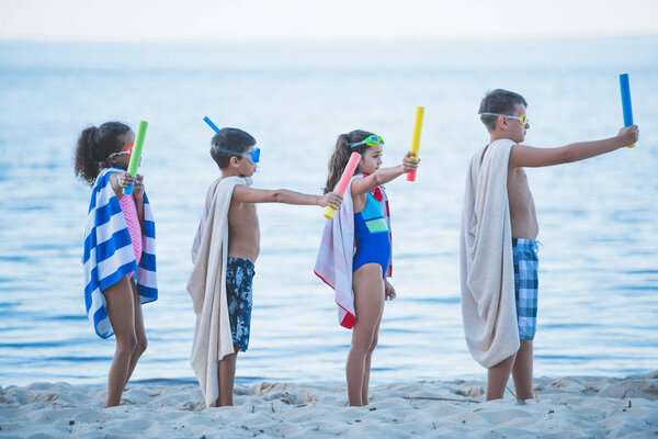 multicultural kids in swimming masks with toys