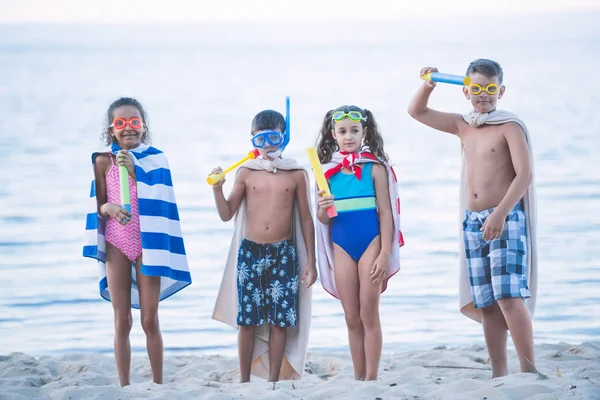 Niños multiculturales en máscaras de natación con juguetes —  Fotos de Stock